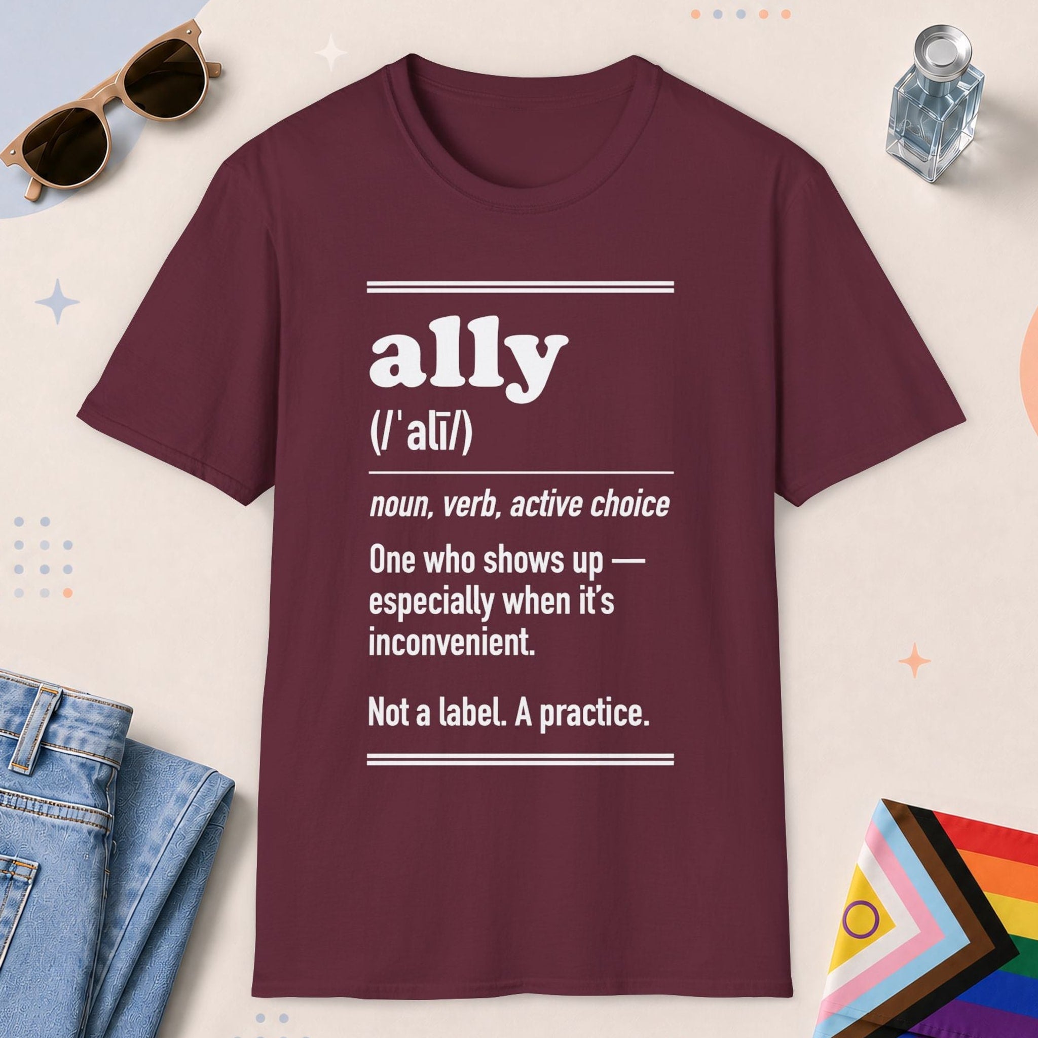 Maroon color all-gender graphic t-shirt with "Ally Definition" design