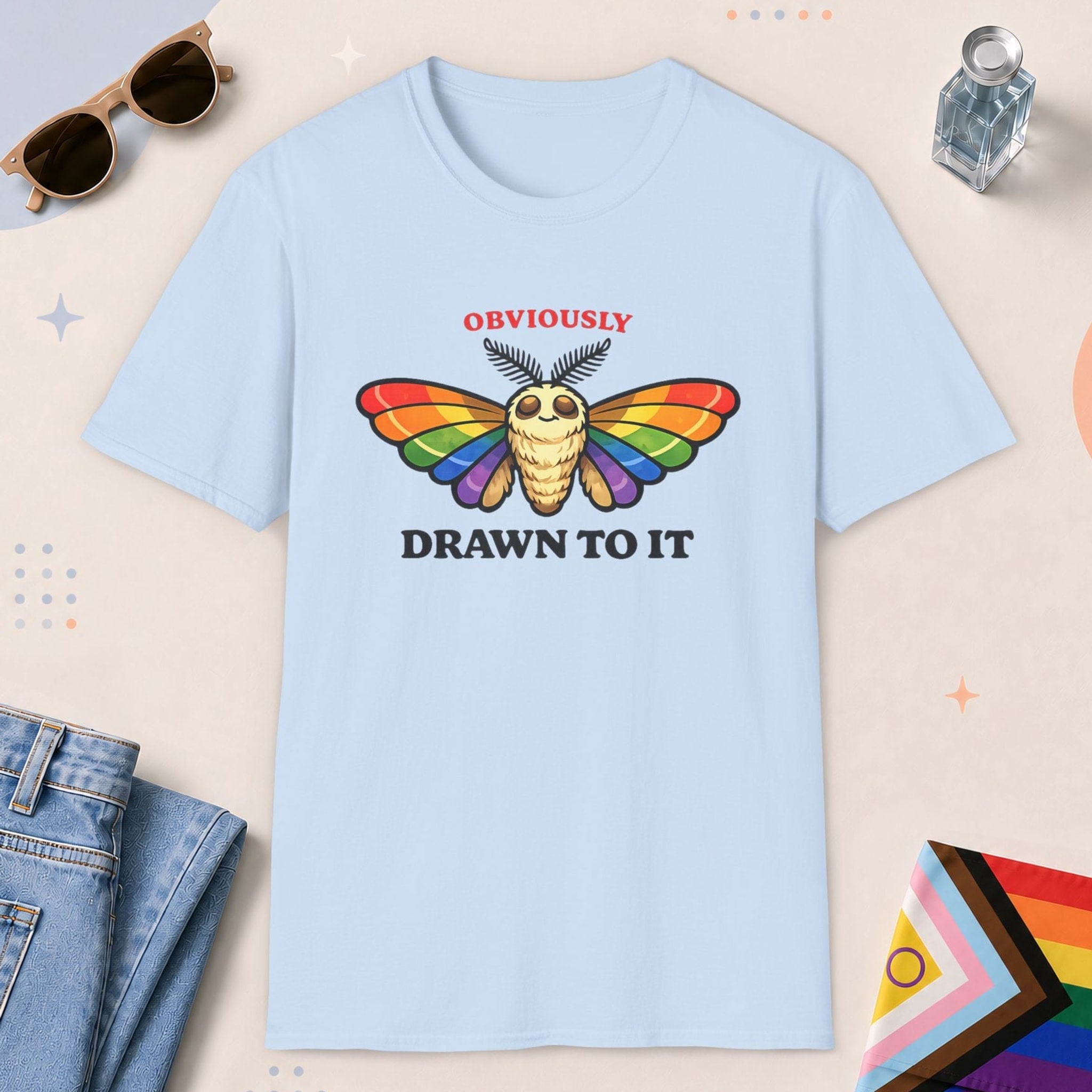 Light Blue color all-gender graphic t-shirt with "Drawn To It" design