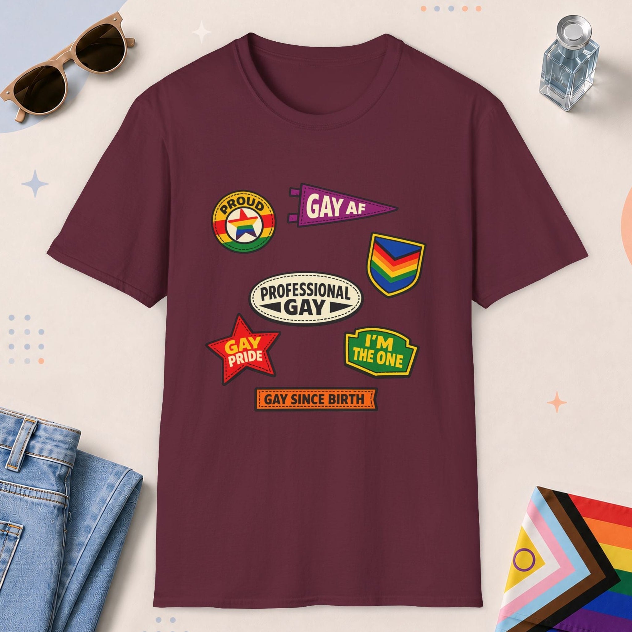 Maroon color all-gender graphic t-shirt with "Gay Badges" design