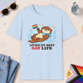 Light Blue color all-gender graphic t-shirt with "Otter Living Best Gay Life" design