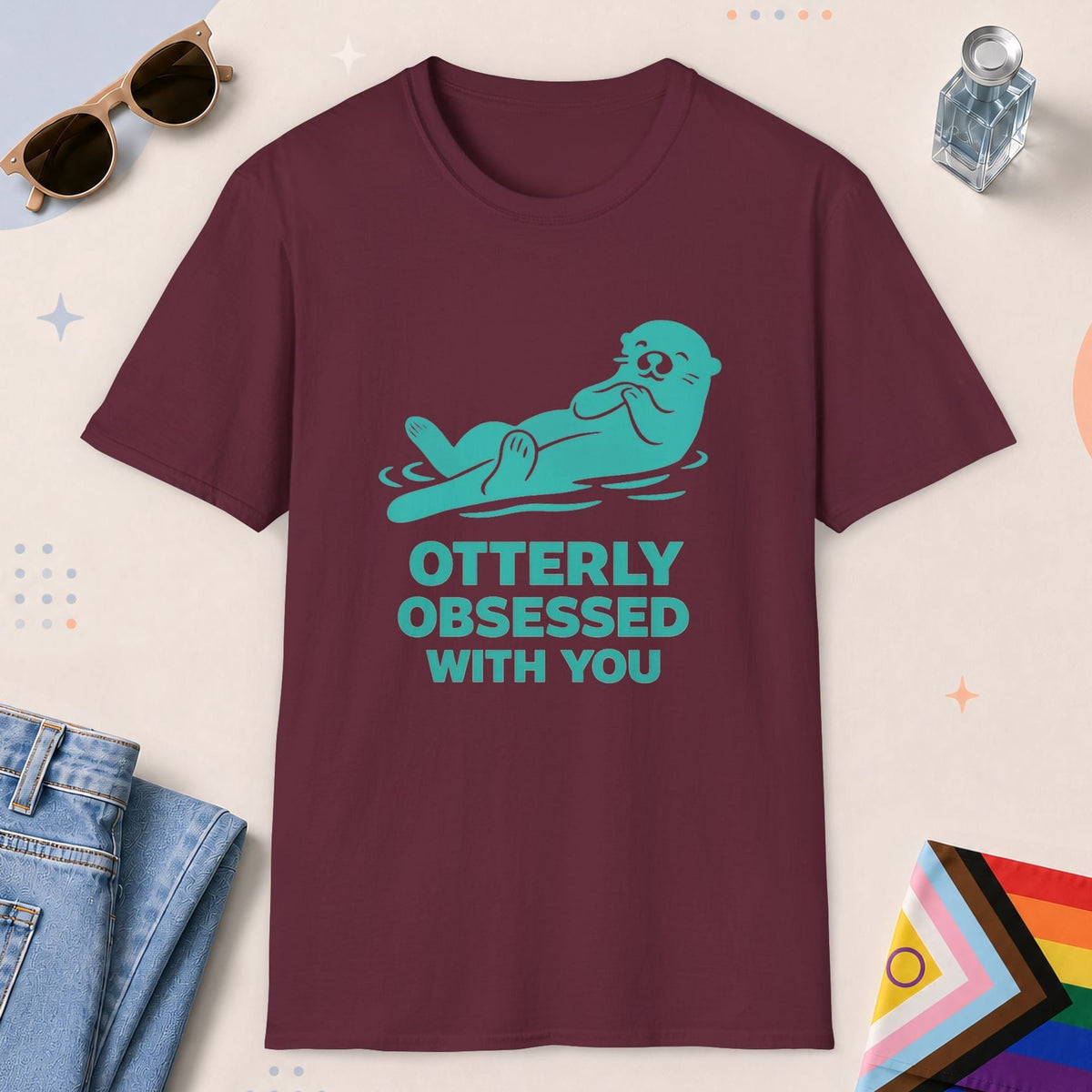 Maroon color all-gender graphic t-shirt with "Otterly Obsessed" design