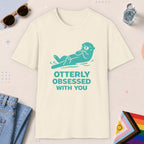Natural color all-gender graphic t-shirt with "Otterly Obsessed" design