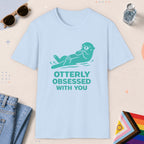 Light Blue color all-gender graphic t-shirt with "Otterly Obsessed" design