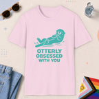 Light Pink color all-gender graphic t-shirt with "Otterly Obsessed" design