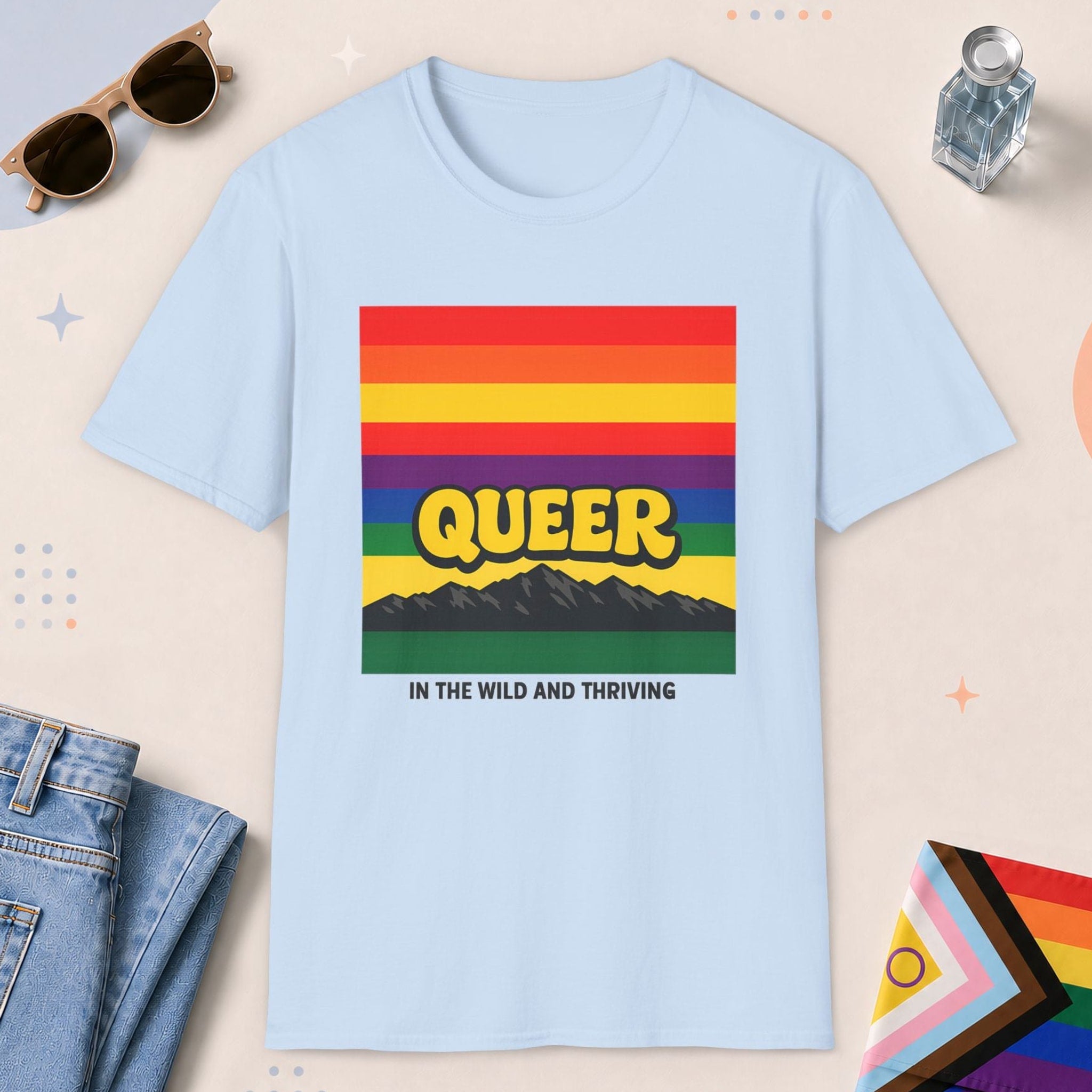 Light Blue color all-gender graphic t-shirt with "Queer In The Wild" design