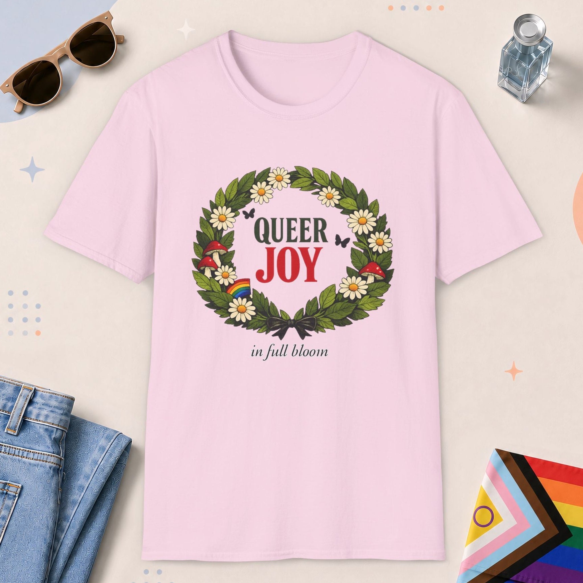 Light Pink color all-gender graphic t-shirt with "Queer Joy" design