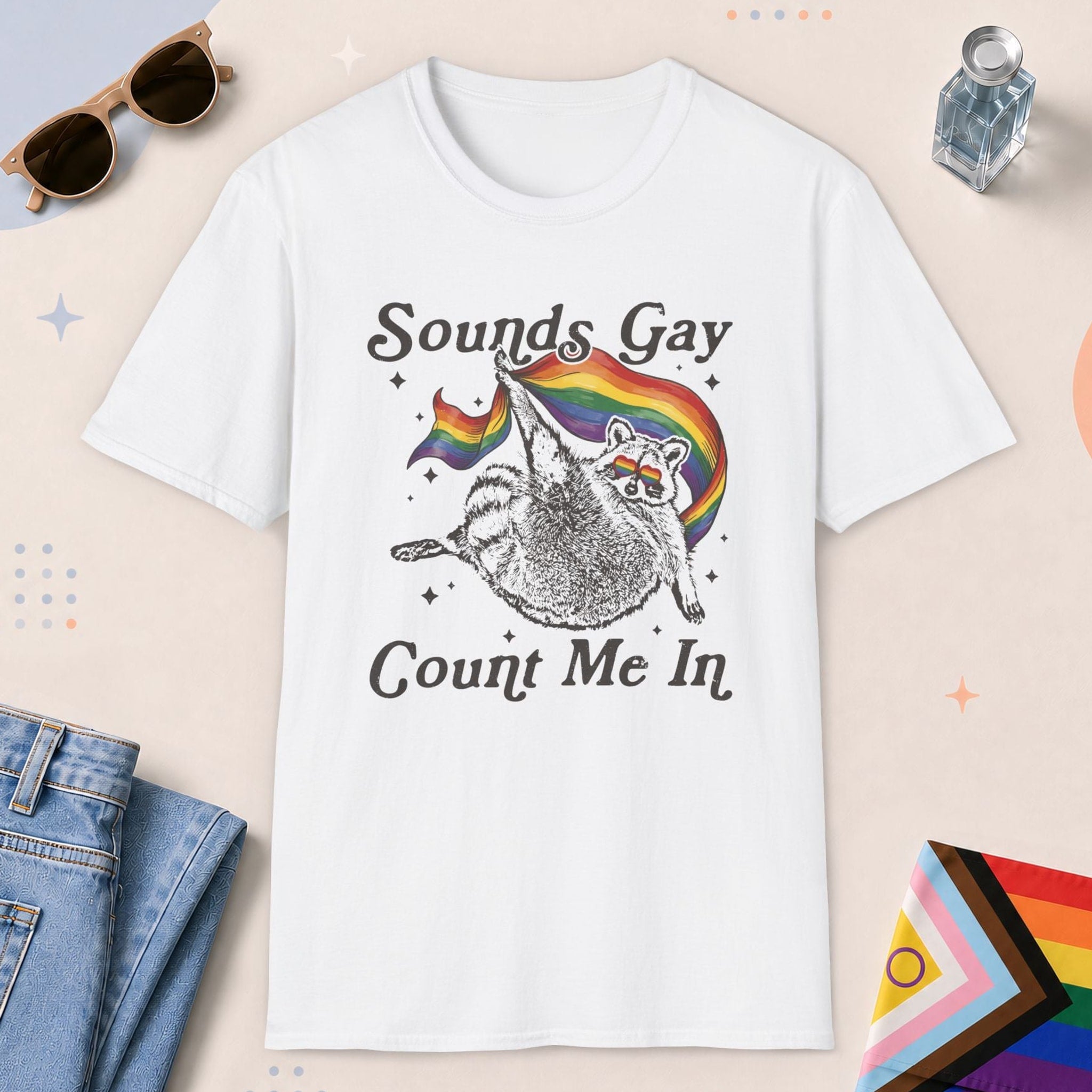 White color all-gender graphic t-shirt with "Sounds Gay Raccoon" design